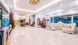 a large living room with couches and a tv at Happy Villa in Sầm Sơn +4 photos