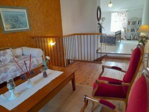 a living room with a couch and a table at Maison en pierres rénovée avec patio à Ferrières-sur-Sichon - FR-1-489-191 in Ferrières-sur-Sichon
