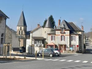 a car parked in front of houses on a street at Maison en pierres rénovée avec patio à Ferrières-sur-Sichon - FR-1-489-191 in Ferrières-sur-Sichon