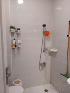 a bathroom with a shower with a toilet and a sink at Aqua Palms Resort D101 in El Gouna