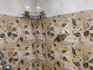 a bathroom with a shower with a wall at Eva Beach Side Room in Mandrem +278 photos