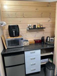 a kitchen with a counter top with a microwave at Te Mata Bay Seaviews in Tapu