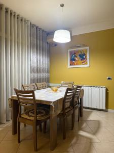 a dining room with a table and chairs at Sunshine Place in Elbasan +35 photos