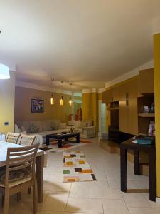 a living room with a couch and a table at Sunshine Place in Elbasan