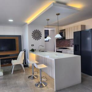 a kitchen with a white counter and a black refrigerator at Luxury Jacuzzi in Poblado in El Poblado