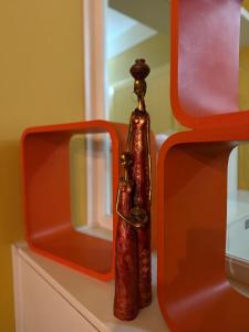 a bottle sitting on a counter with two mirrors at Sunshine Place in Elbasan