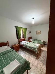 a bedroom with two beds and a window in it at Triana Guest House in Foz do Iguaçu +56 photos