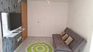 a living room with a couch and a flat screen tv at Sidnei Ferreira da Silva in Presidente Prudente