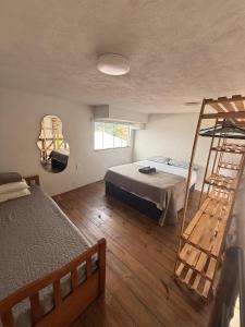 a bedroom with two bunk beds and a ladder at Casaboa Apartamentos Passarela in Itacaré