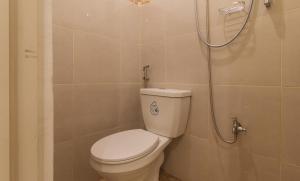 a bathroom with a toilet and a shower at G Fam Transient by RedDoorz in Manila +31 photos