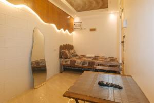 a living room with a couch and a table at G Fam Transient by RedDoorz in Manila