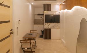 a small dining room with a table and a tv at G Fam Transient by RedDoorz in Manila
