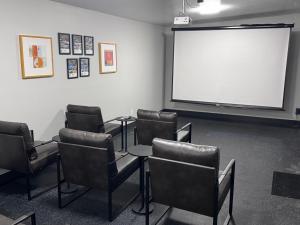 a meeting room with chairs and a white screen at Oceanside Villas in Sechelt
