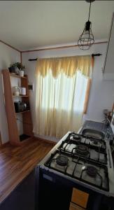 a kitchen with a stove top in a room at Cabaña Evaristo Ivan in Frutillar +16 photos