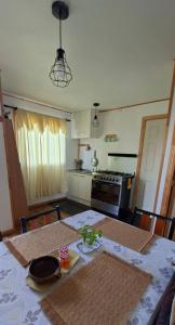 a kitchen with a table with a table cloth on it at Cabaña Evaristo Ivan in Frutillar