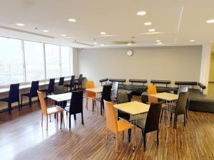 a dining room with tables and chairs at Green Rich Hotel Kagoshima Tenmonkan in Kagoshima