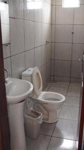 a bathroom with a toilet and a sink at Sítio Resenha in Caucaia +11 photos