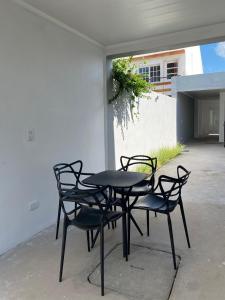 a black table and chairs on a patio at Gris Urbano in Federación