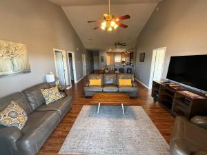 a living room with a couch and a flat screen tv at Lakefront and Lake View Condo on Indian Point in Branson