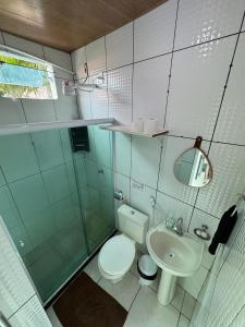 a small bathroom with a toilet and a sink at Pousada Shamah - Morro de São Paulo in Morro de São Paulo