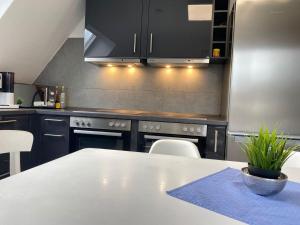 a kitchen with a white table and a counter top at Modern Good Location in Hamburg