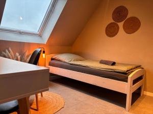 a small room with a bed in the attic at Modern Good Location in Hamburg