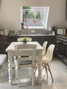 a white table and chairs in a kitchen at Modern Good Location in Hamburg