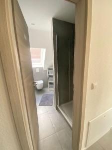 a bathroom with a shower with a glass door at Modern Good Location in Hamburg