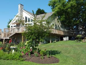 a garden in front of a house with a tree at Gettysburg Battlefield Bed & Breakfast Inn in Gettysburg