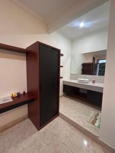 a large bathroom with a sink and a mirror at Pantai Ayu Homestay in Padangbai