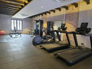 a gym with treadmills and ellipticals in a room at Baba House Melaka in Malacca