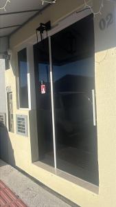 a large glass door on the side of a building at Kitnet com ar-condicionado e entrada privativa SC in Itajaí