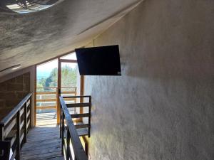 a flat screen tv on the wall of a room at Cabañas El Marqués Zacatlán con Starlink in Zacatlán