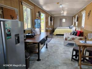 a kitchen with a refrigerator and a room with a bed at Quinta Aroma Zempoala in Zempoala