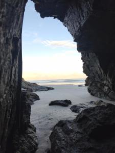 a view of the beach through a rock cave at Canto da restinga in Paranaguá