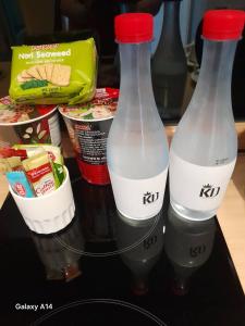 two bottles of milk on a table with food at Zen Next Khao Yai By ZV in Pak Chong