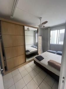 a bedroom with a large mirror and a bed at Campinas in São José