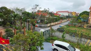 a white car parked in a parking lot at Rose House - Quảng Bình in Bố Trạch