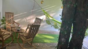 two chairs and a table and a tree at Casa Tamarindo in Las Peñitas