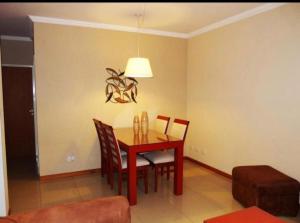 a dining room with a red table and chairs at Zárate Temporarios in Zárate +4 photos