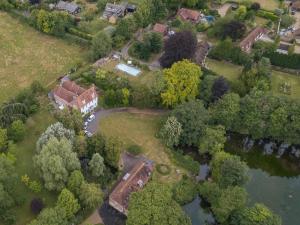 an aerial view of a estate with a house and trees at Heron Barn in Hollingbourne