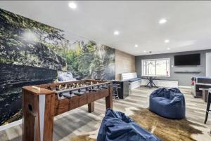 a room with a foosball table and a large wall at Arrowhead Lakefront Chalet Private Lake Access in Pocono Lake
