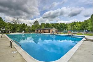 a large swimming pool with blue water at Arrowhead Lakefront Chalet Private Lake Access in Pocono Lake