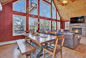 a dining room with a table and a fireplace at Arrowhead Lakefront Chalet Private Lake Access in Pocono Lake
