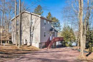 a house with a staircase in front of it at Arrowhead Lakefront Chalet Private Lake Access in Pocono Lake