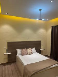 a bedroom with a large bed with two tables at Résidence MBK Suite in Ziguinchor