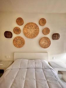 a bedroom with wooden plates on the wall at Paulas Suites Terraza in Ixtapa