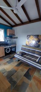 a room with a bed in the middle of a room at Bungaillou in Lamentin