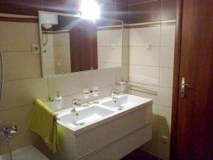a bathroom with a white sink and a mirror at Apartment in Okrug Gornji 6167 in Trogir