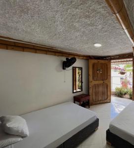 a bedroom with a large bed and a window at Hotel La Casona Quindío Eje Cafetero in Montenegro +6 photos